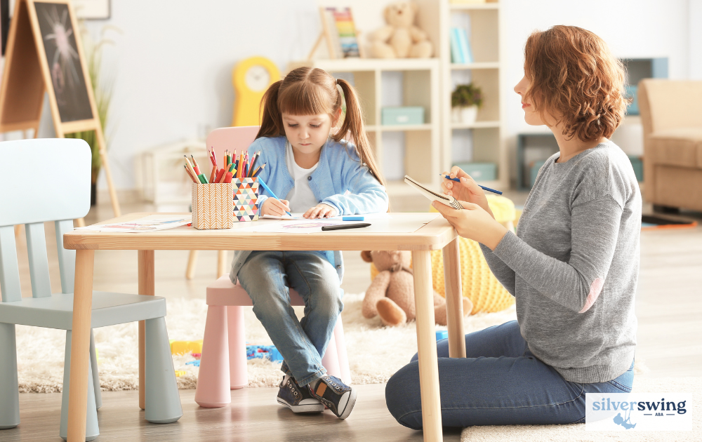 ABA therapist working with a child at a table