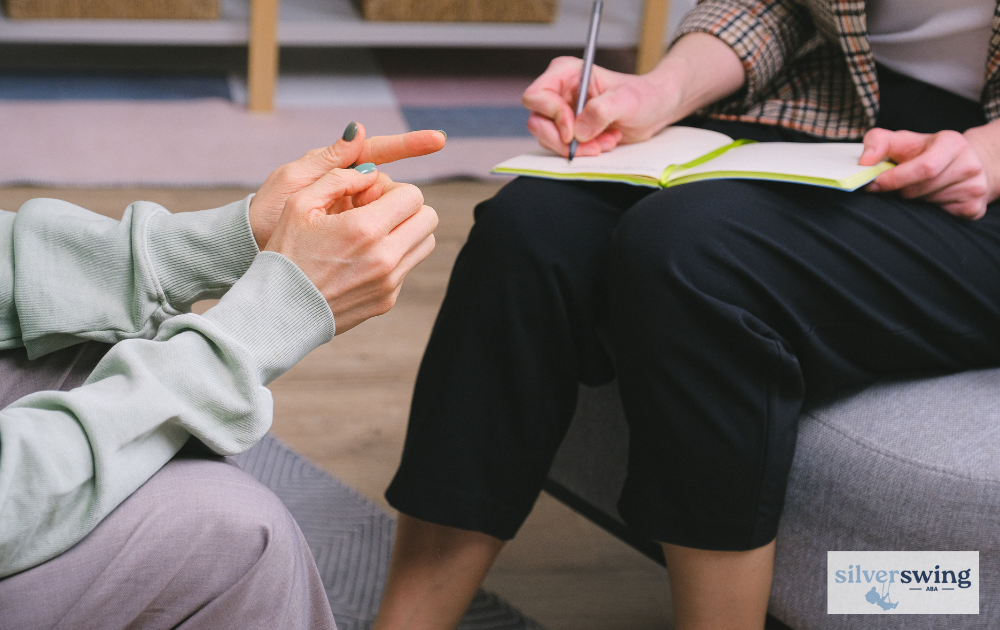 ABA therapist taking notes during a therapy session.
