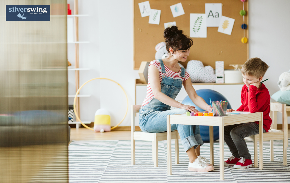 ABA therapist working with a child in a classroom