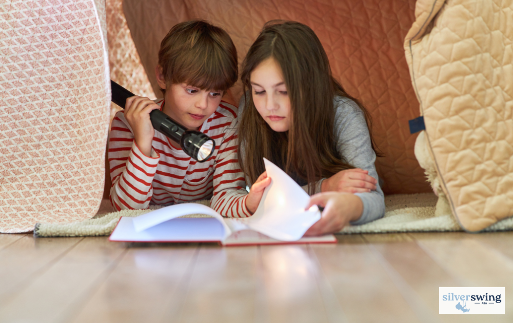 Children reading with a flashlight