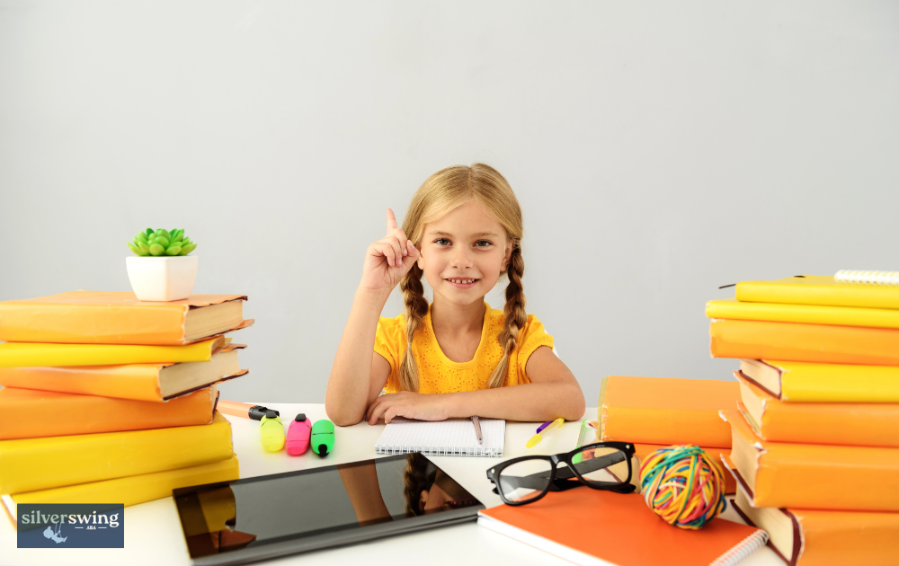 Smiling girl at desk with books